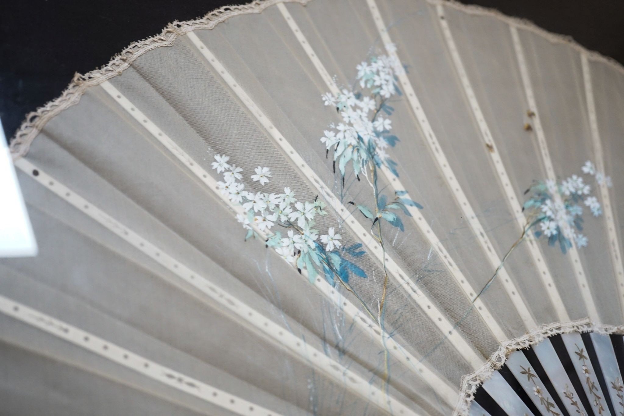 A framed 19th century French mother of pearl and painted silk fan, approx. 60cm long excl frame